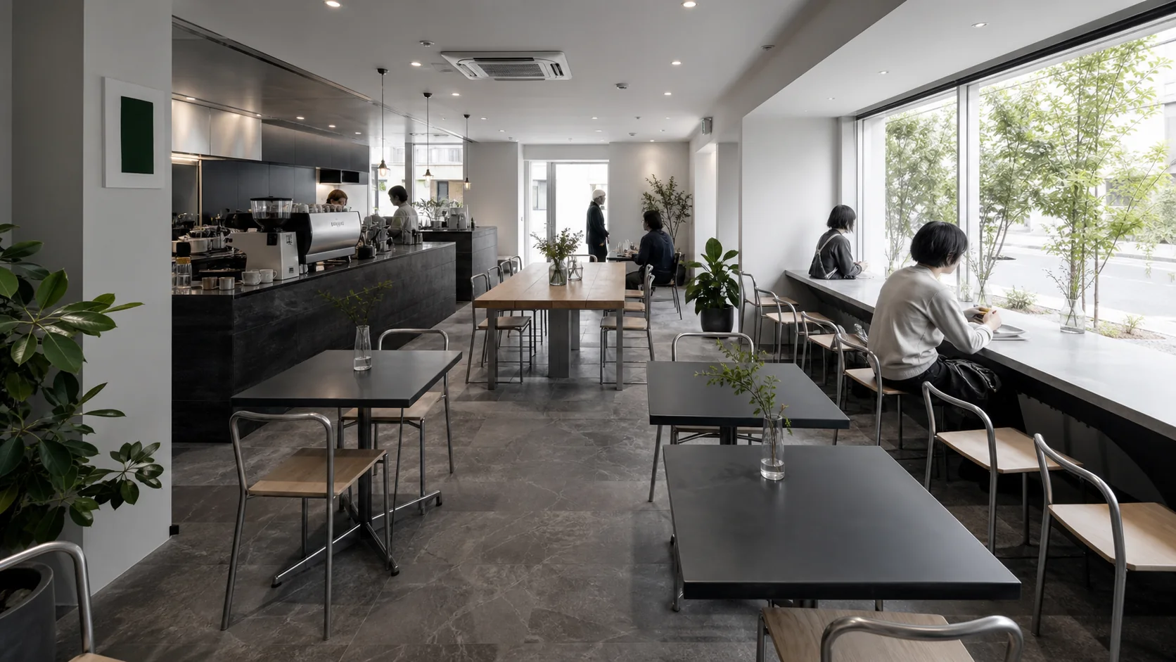 白い壁とチャコール色のカウンターがある明るい店内